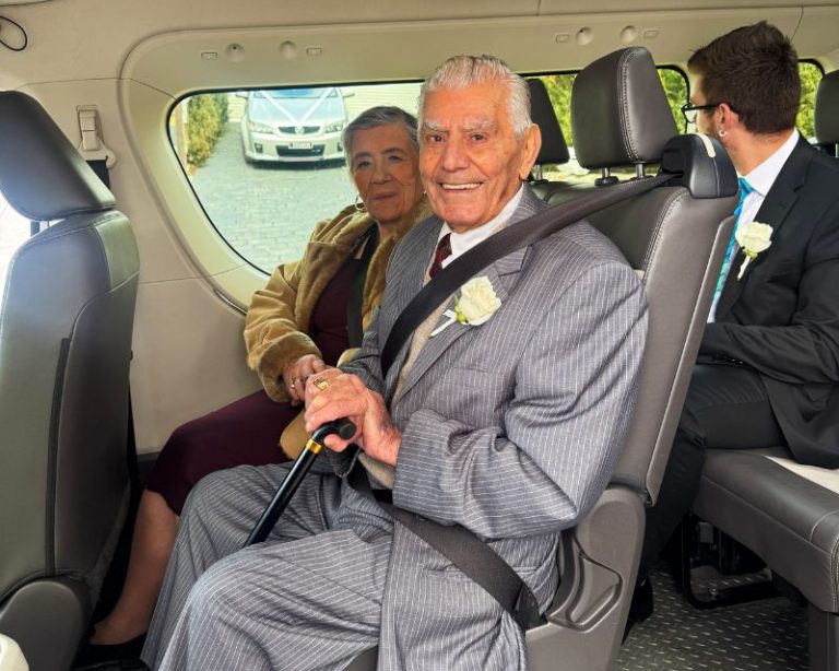 Elderly couple seated inside maxi cab for Melbourne transfer