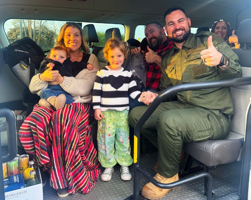 Easy Maxi Cabs group transfer with family of passengers smiling inside maxi van